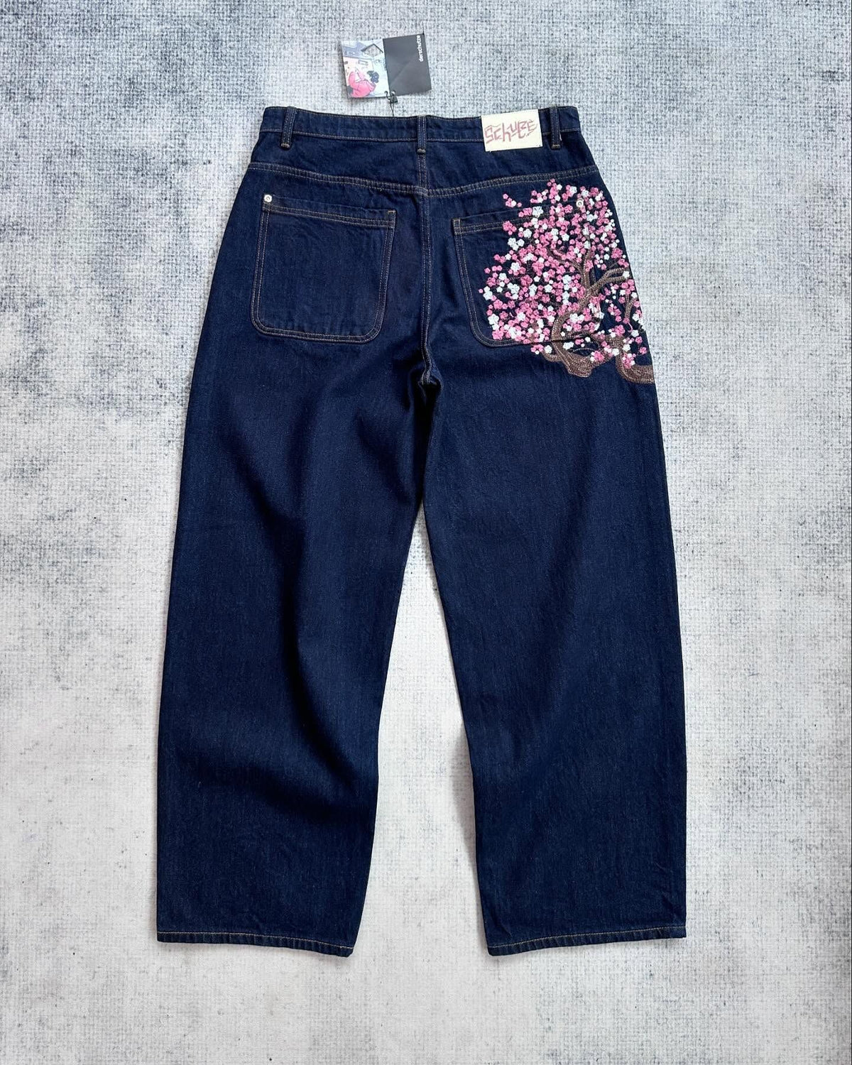 ODMPOD high-waisted straight leg embroidered jeans, stylish denim bottoms with intricate embroidery details.