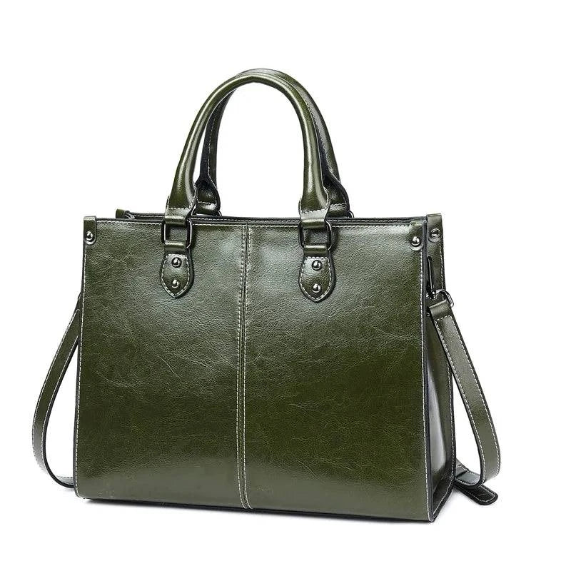 Women's genuine leather top handle handbag with urban style, featuring a sleek design and sturdy leather construction.