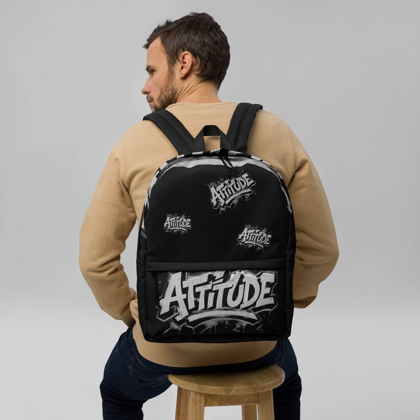 Black Craftklart.store Attitude backpack with all-over white print, front view showing adjustable straps and stylish design.