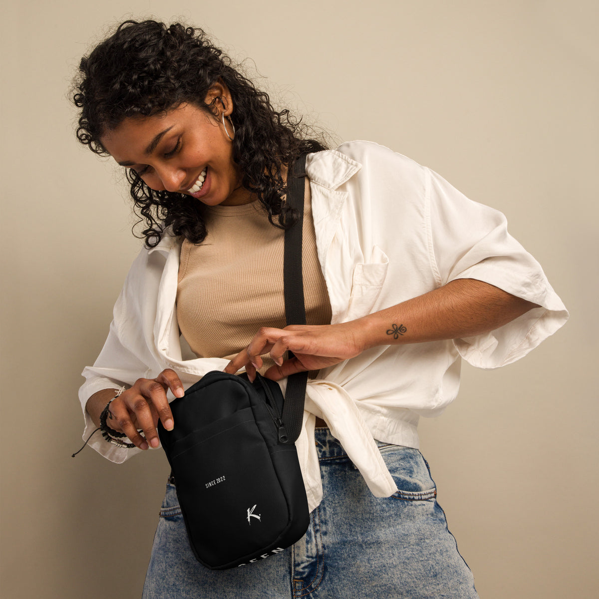 ODMPOD Urban Form Utility Crossbody Bag with all-over print, white fabric, front view showing multiple storage compartments.