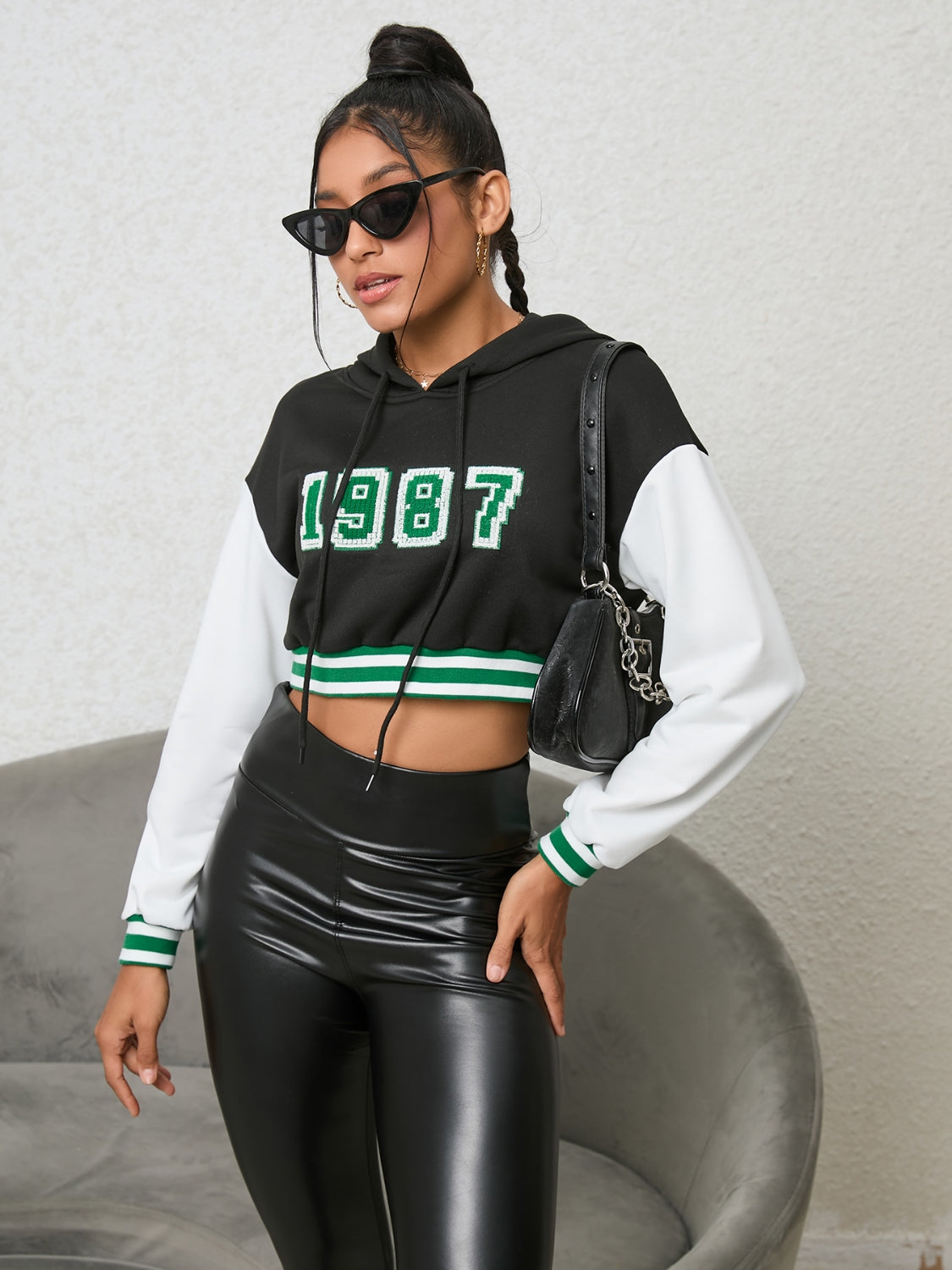 1987 Graphic Cropped Hoodie - Premium Hoodie from Trendsi - Just $24.32! Shop now at Craftklart.store