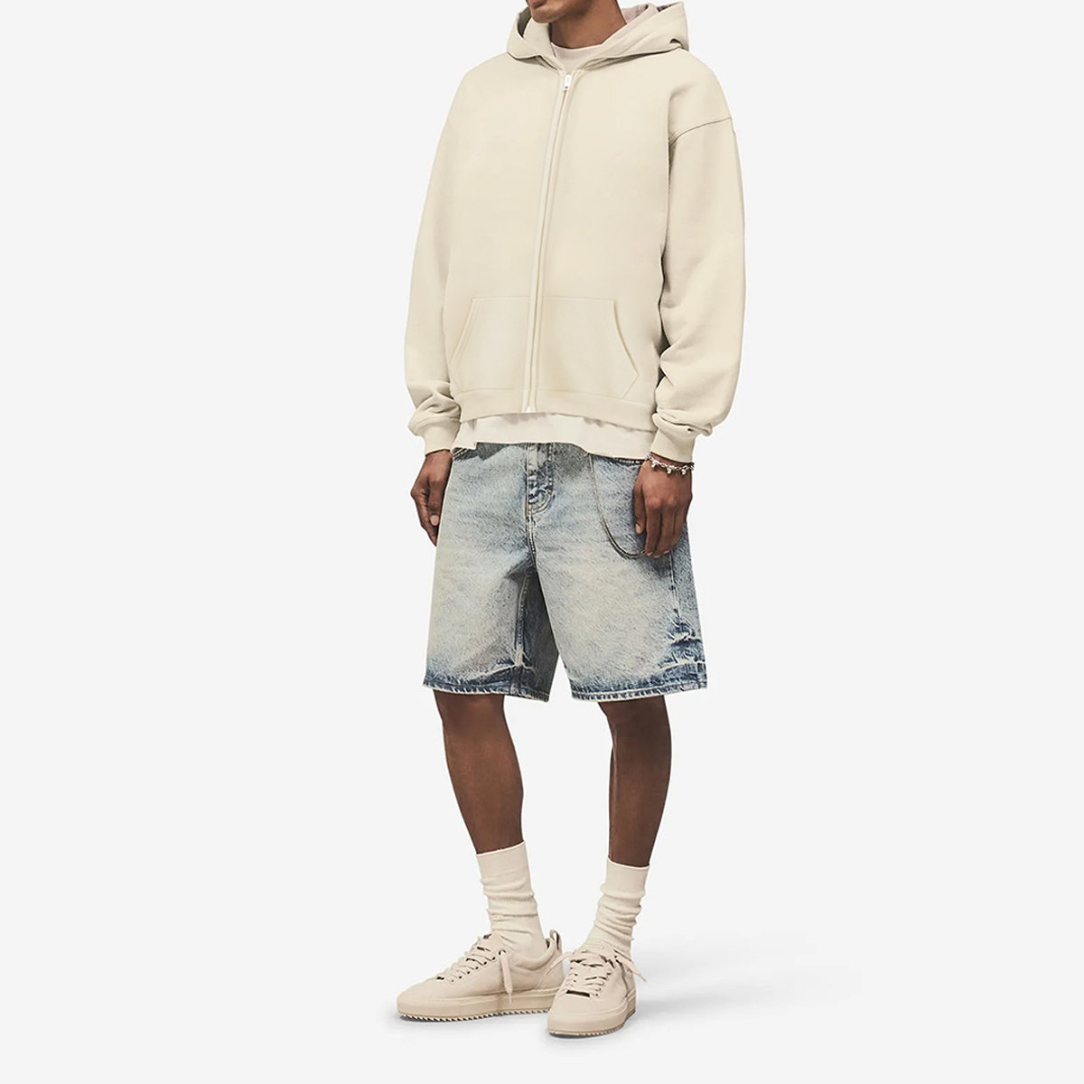 Unisex oversized cropped zip-up hoodie in heavyweight 460GSM fabric, featuring a front zipper and hood, in urban streetwear style.