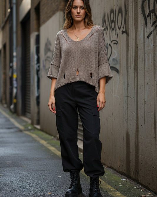 Urban Fashion & Streetwear knit sweater featuring a cutout 3/4 sleeve design and minimal structured knit detailing.