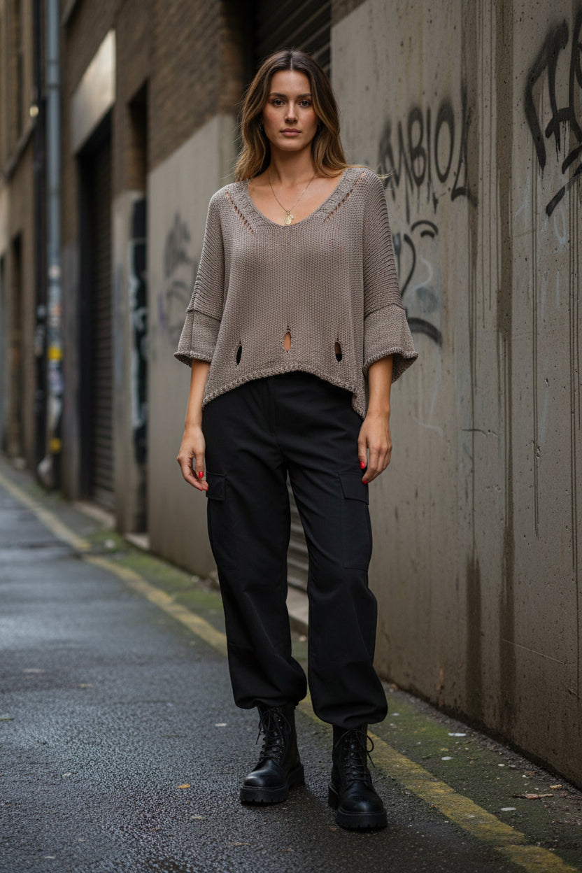 Urban Fashion & Streetwear knit sweater featuring a cutout 3/4 sleeve design and minimal structured knit detailing.