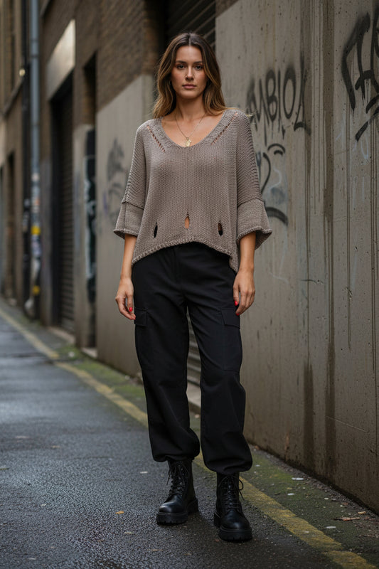Urban Fashion & Streetwear knit sweater featuring a cutout 3/4 sleeve design and minimal structured knit detailing.