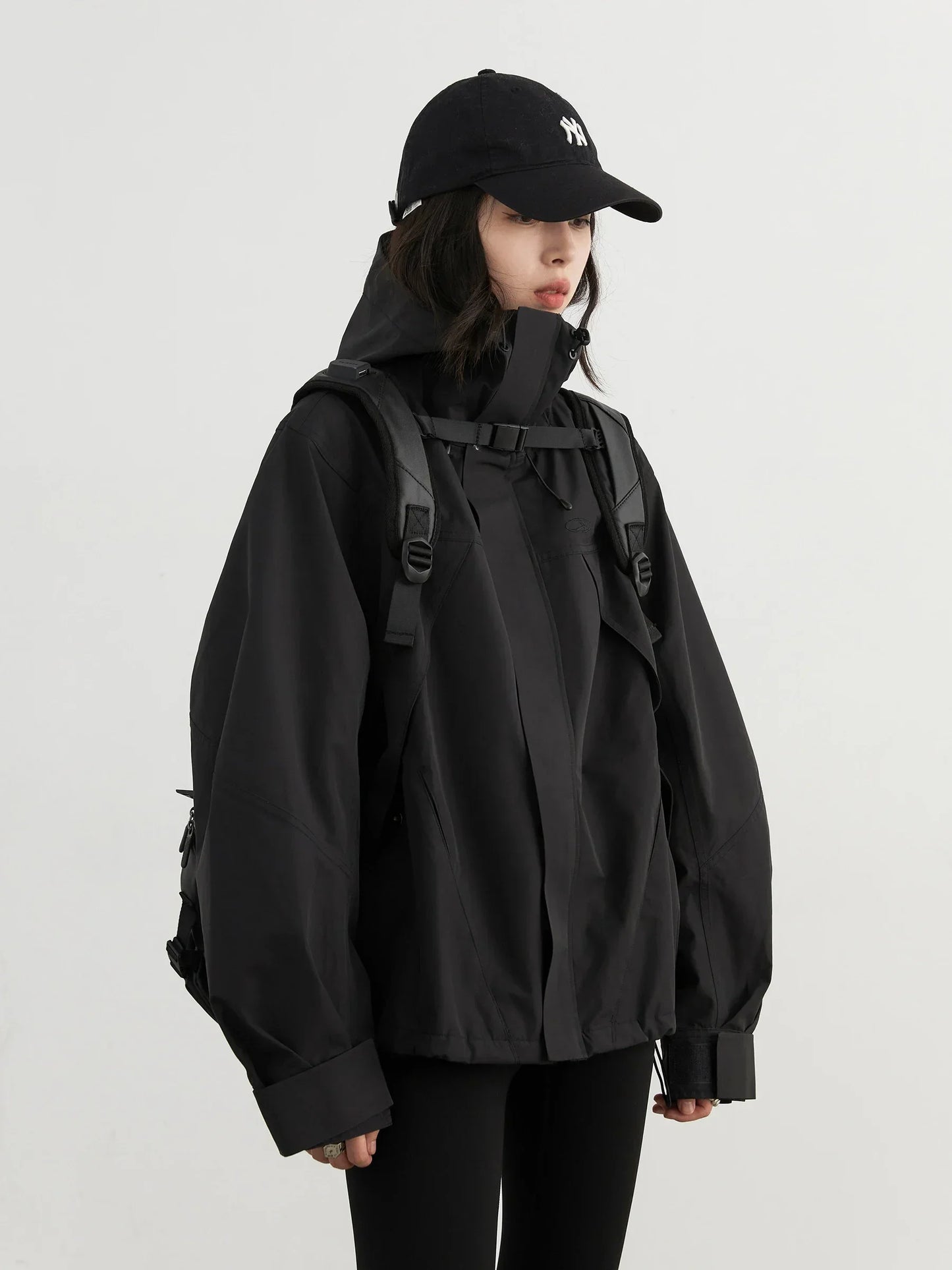 Women’s hooded windproof jacket by Craftklart, oversized streetwear coat, featuring a hood and wind-resistant outer layer.