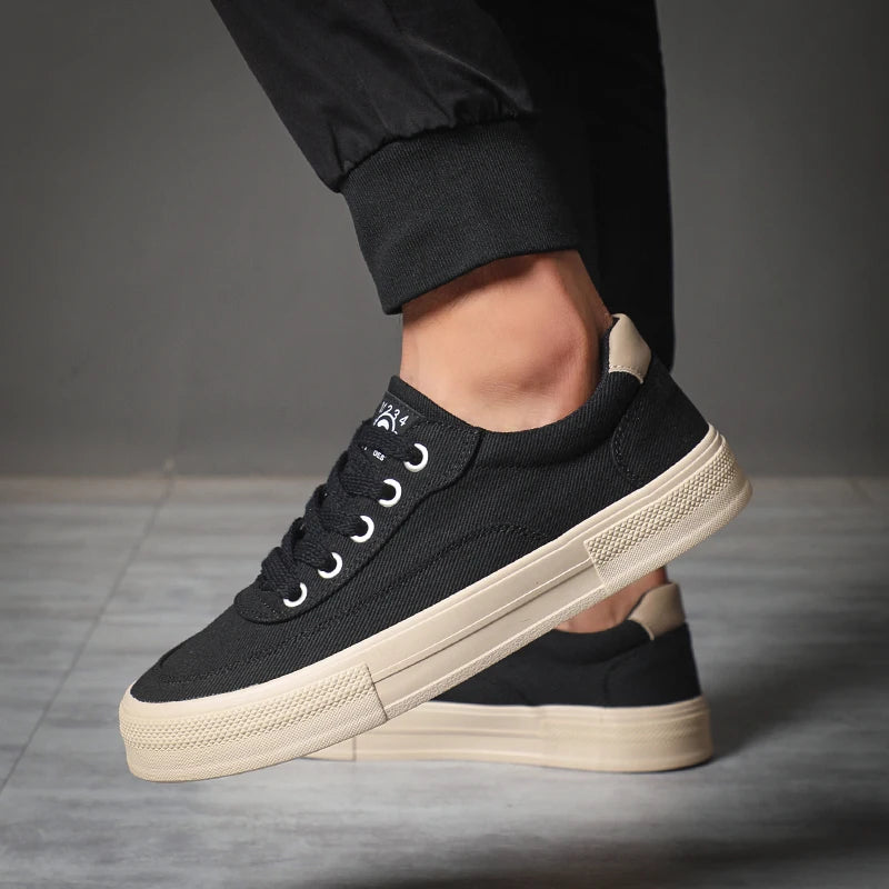 Craftklart low canvas sneaker showing a white and beige design with laces and a rubber sole.