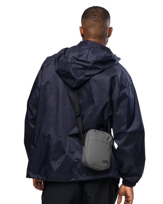 Urban Street Utility Crossbody Bag by Craftklart.store featuring all-over print design in white with front zipper pocket.