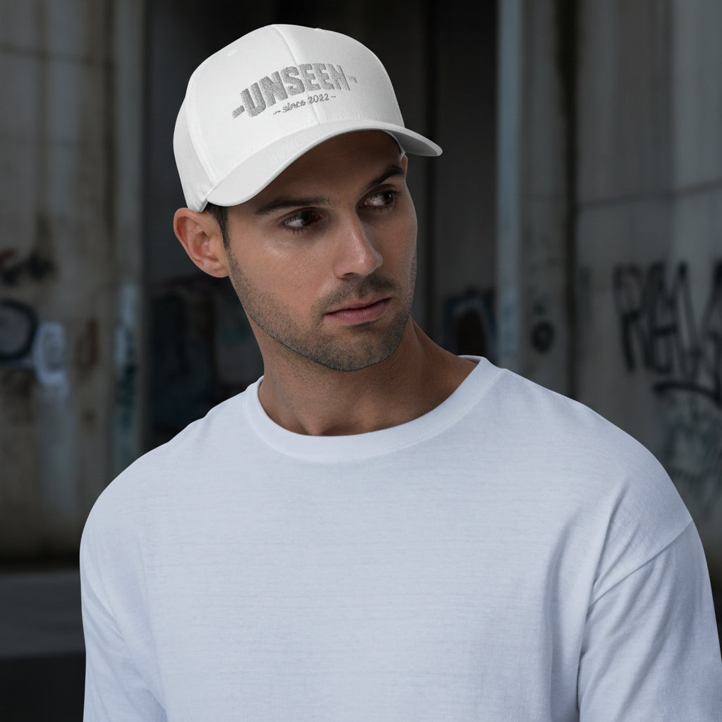 White Craftklart structured twill cap with a closed-back design and curved brim, showcasing a stylish and durable cap style.