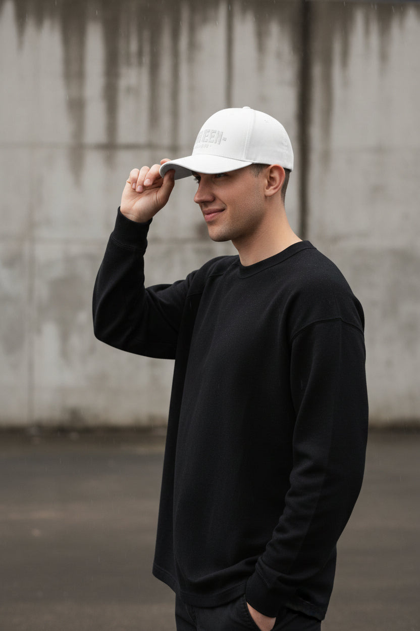 White Craftklart structured twill cap with a closed back, featuring a classic design and adjustable strap.