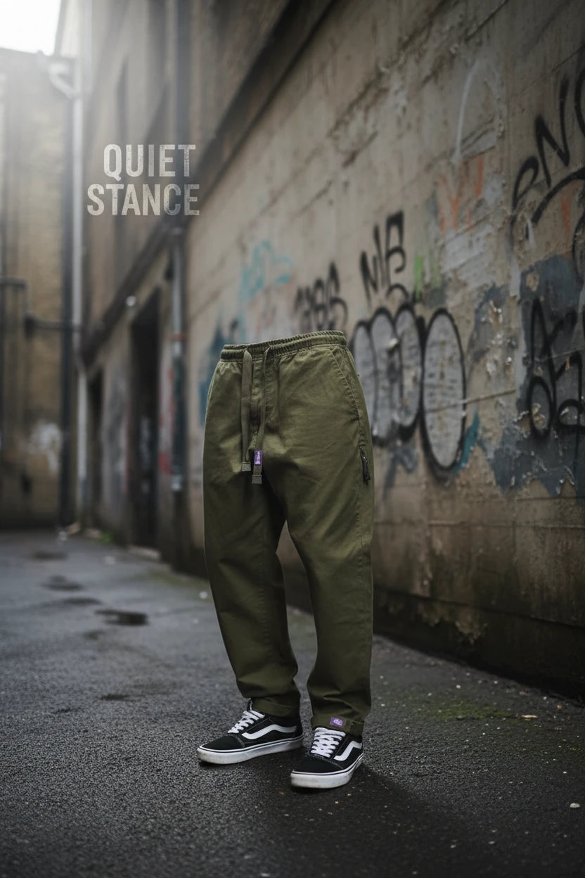 Gray men's cargo pants with a baggy tapered fit, made of cotton, featuring multiple pockets and streetwear style.