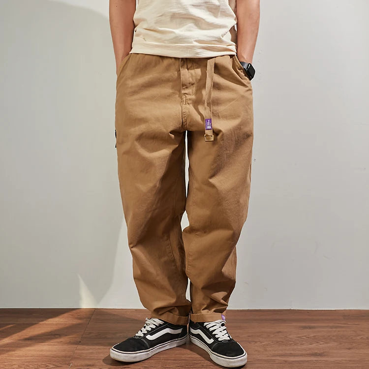 Gray men's cargo pants from Craftklart Dropship featuring a baggy, tapered fit and streetwear style, made of comfortable cotton.