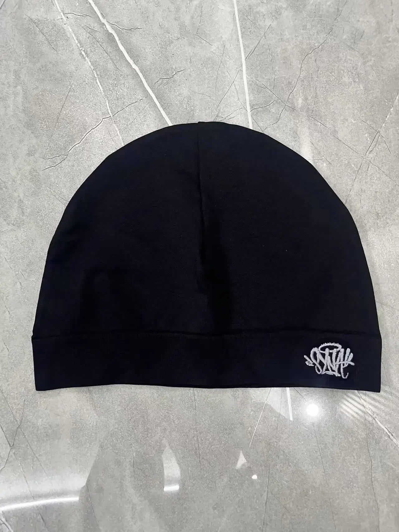 Black Fabric Sy-na Styled Beanie Hat by Craftklart Dropship, cozy knit hat with a snug fit and modern design.