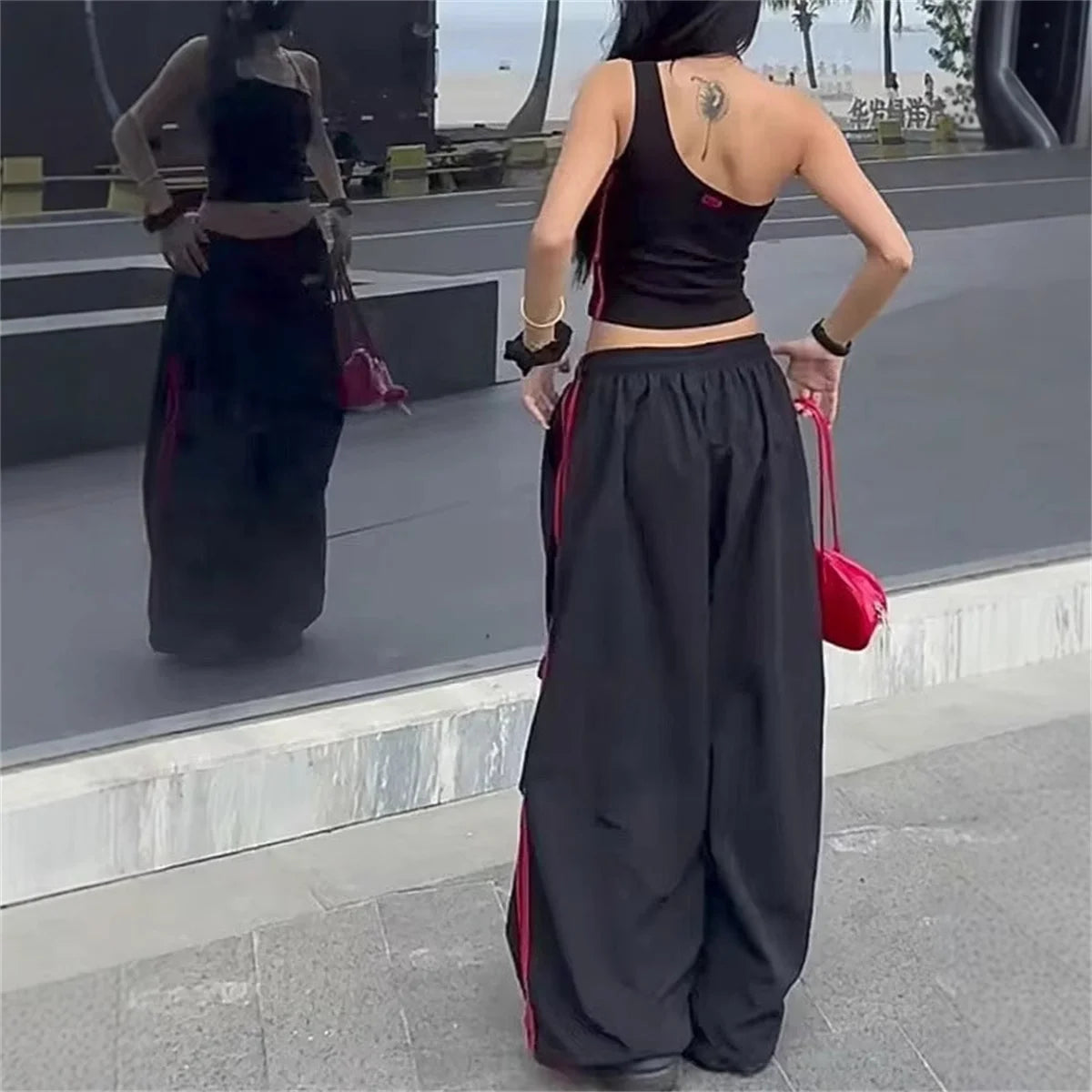 Women's red and black wide-leg cargo joggers by Craftklart Dropship, featuring baggy fit and streetwear style.