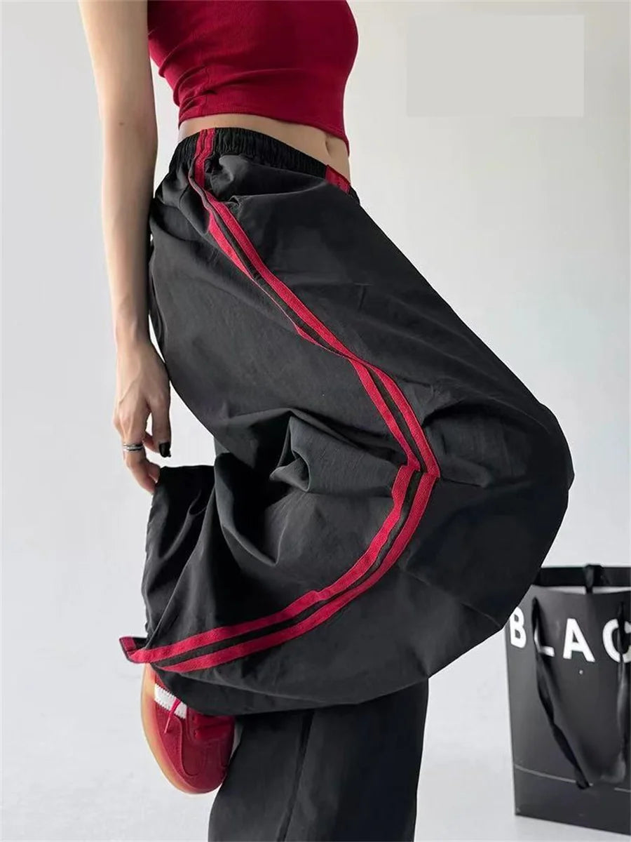 Red women's wide-leg cargo joggers by Craftklart Dropship, featuring baggy fit and streetwear style with cargo pockets.
