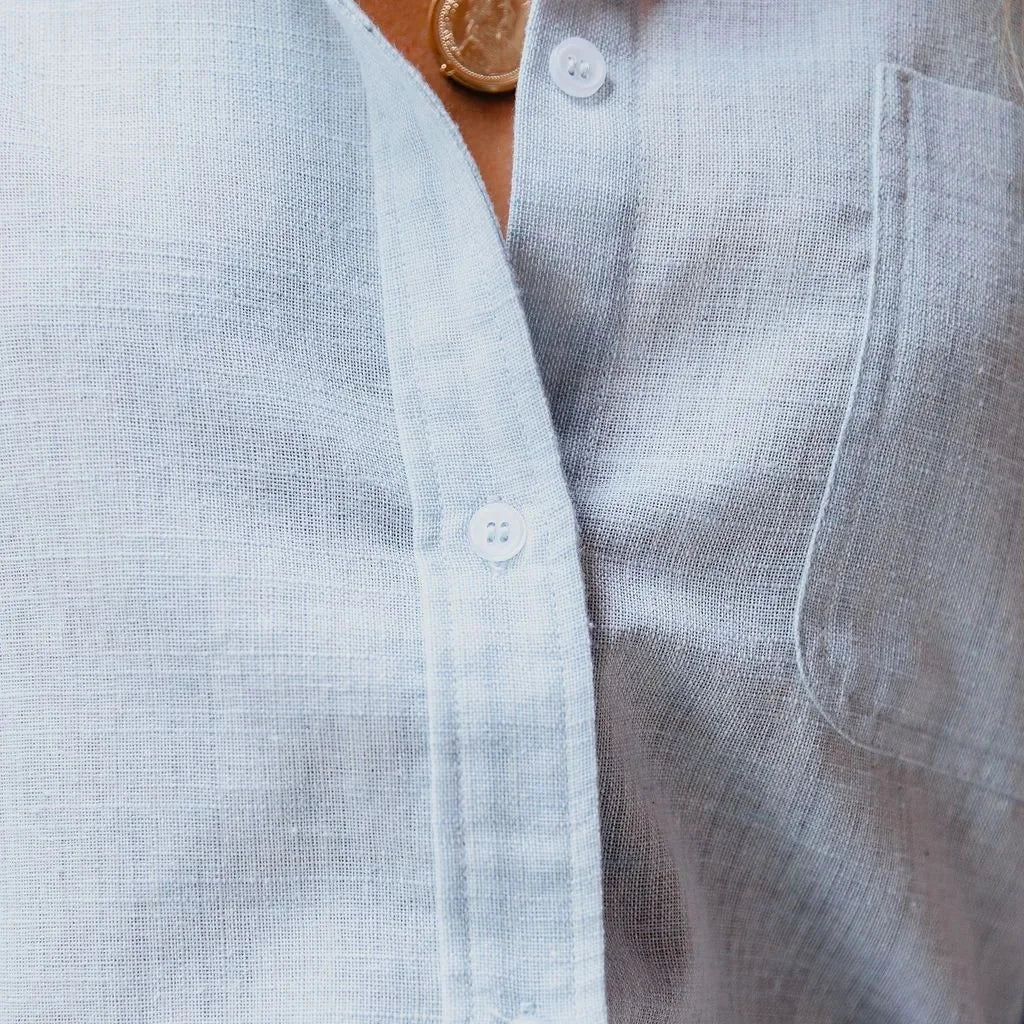 White women's loose cotton linen shirt by Craftklart Dropship, relaxed fit with breathable fabric and casual style.