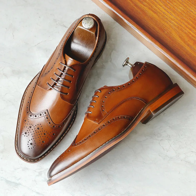 Men's black genuine leather carved brogue dress shoes with detailed perforations and classic lace-up design.
