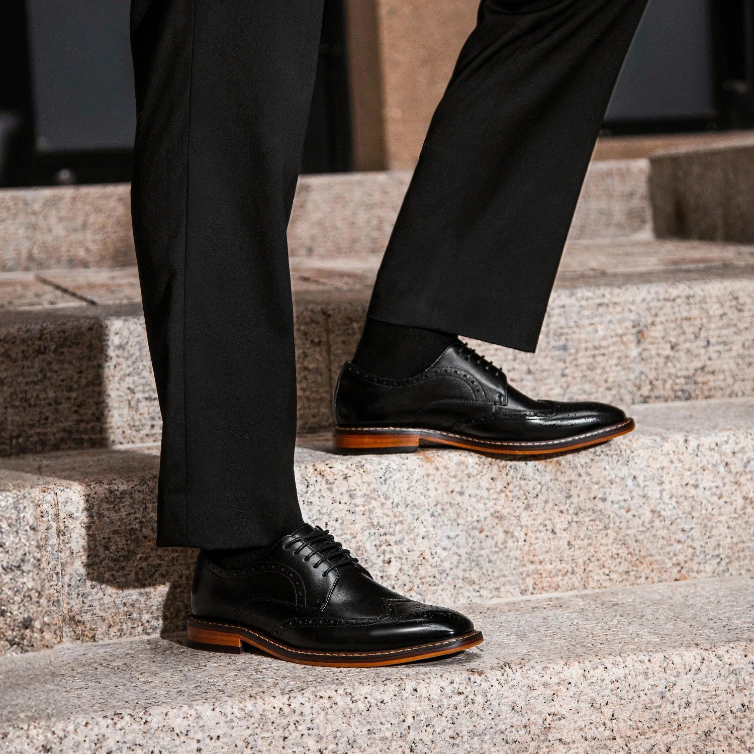 Men's black genuine leather carved brogue dress shoes with detailed perforations and classic lace-up design.