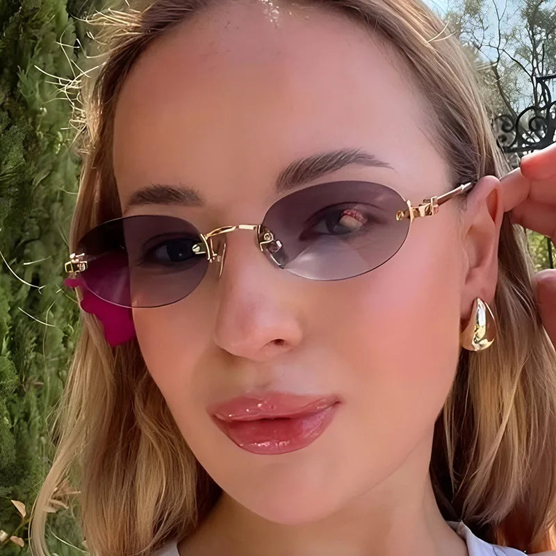 Women's frameless oval sunglasses by Craftklart Dropship with gold and pink accents, UV400 protection for summer wear.