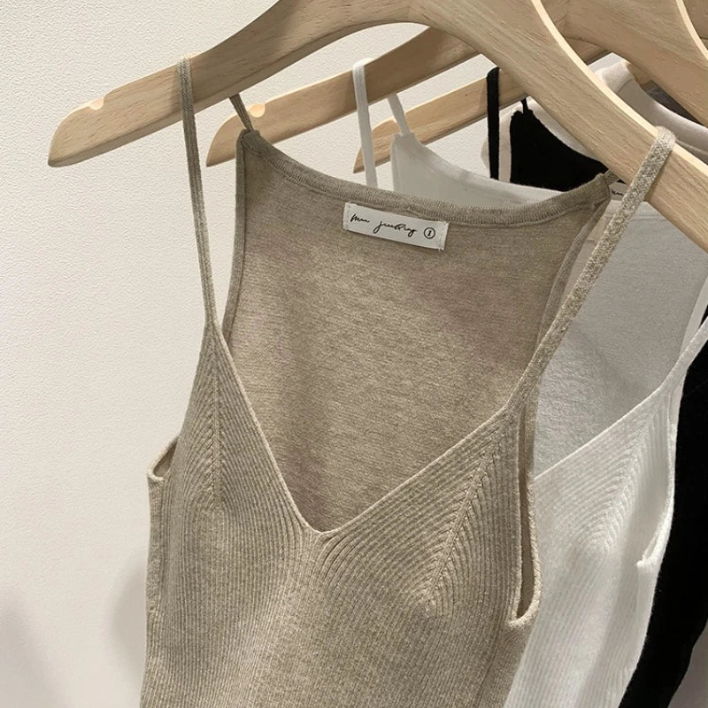 Black women's slim fit V-neck knit tank top, sleeveless cami vest by Craftklart Dropship, shown on a model.