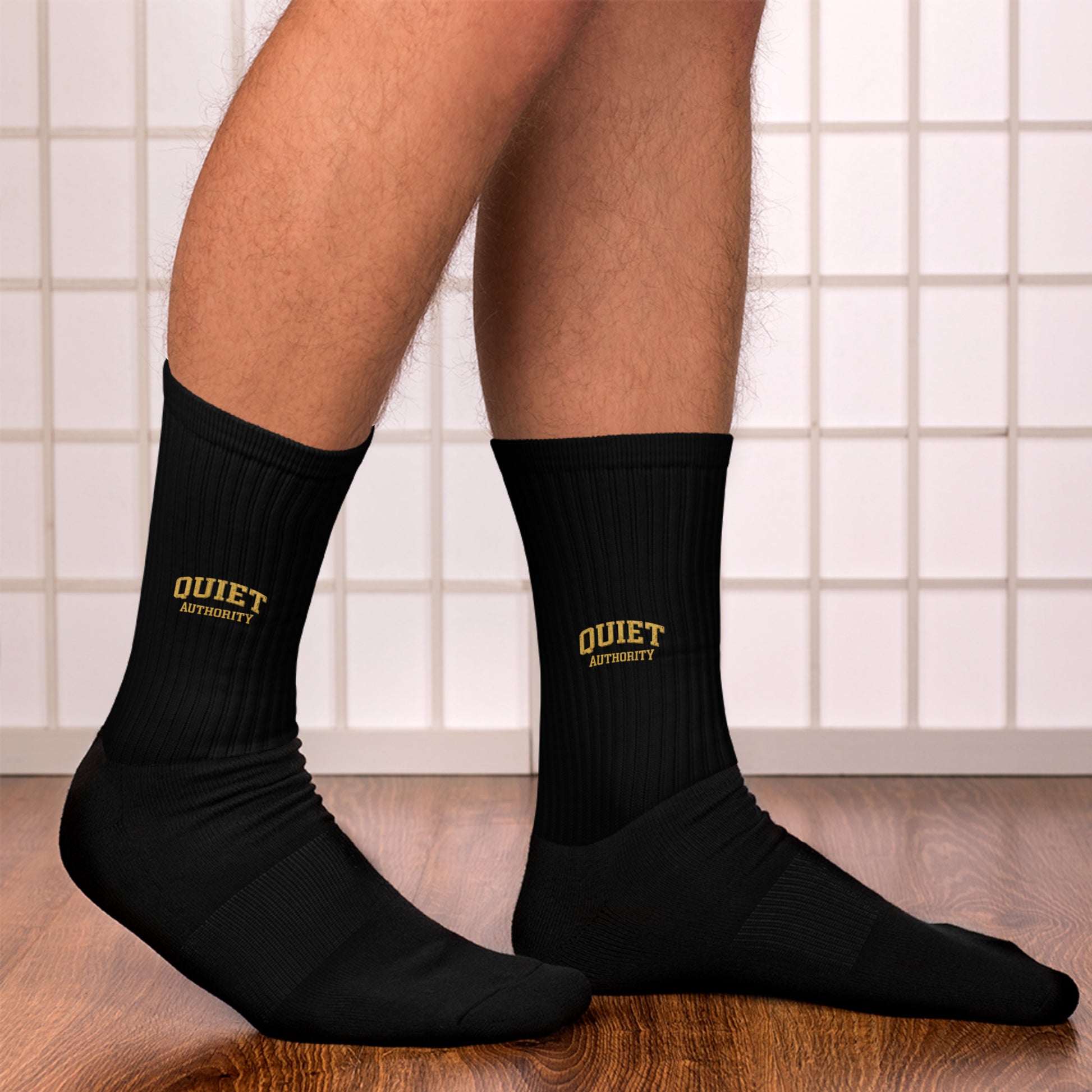 Black Quiet Authority crew socks by Craftklart with vibrant sublimated print, designed for comfortable everyday wear.