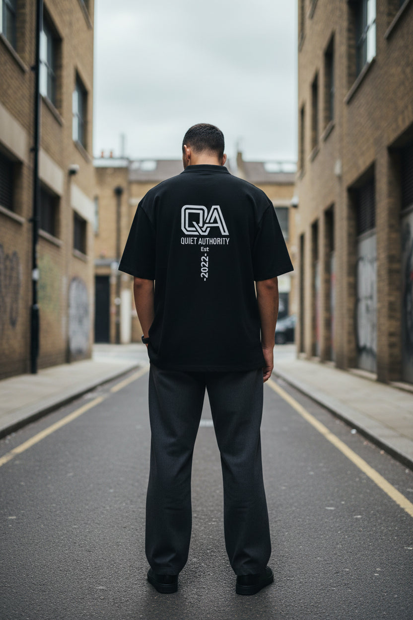 Unisex black Craftklart Piqué Polo Shirt with a clean back design, showcasing premium fabric and classic polo style.
