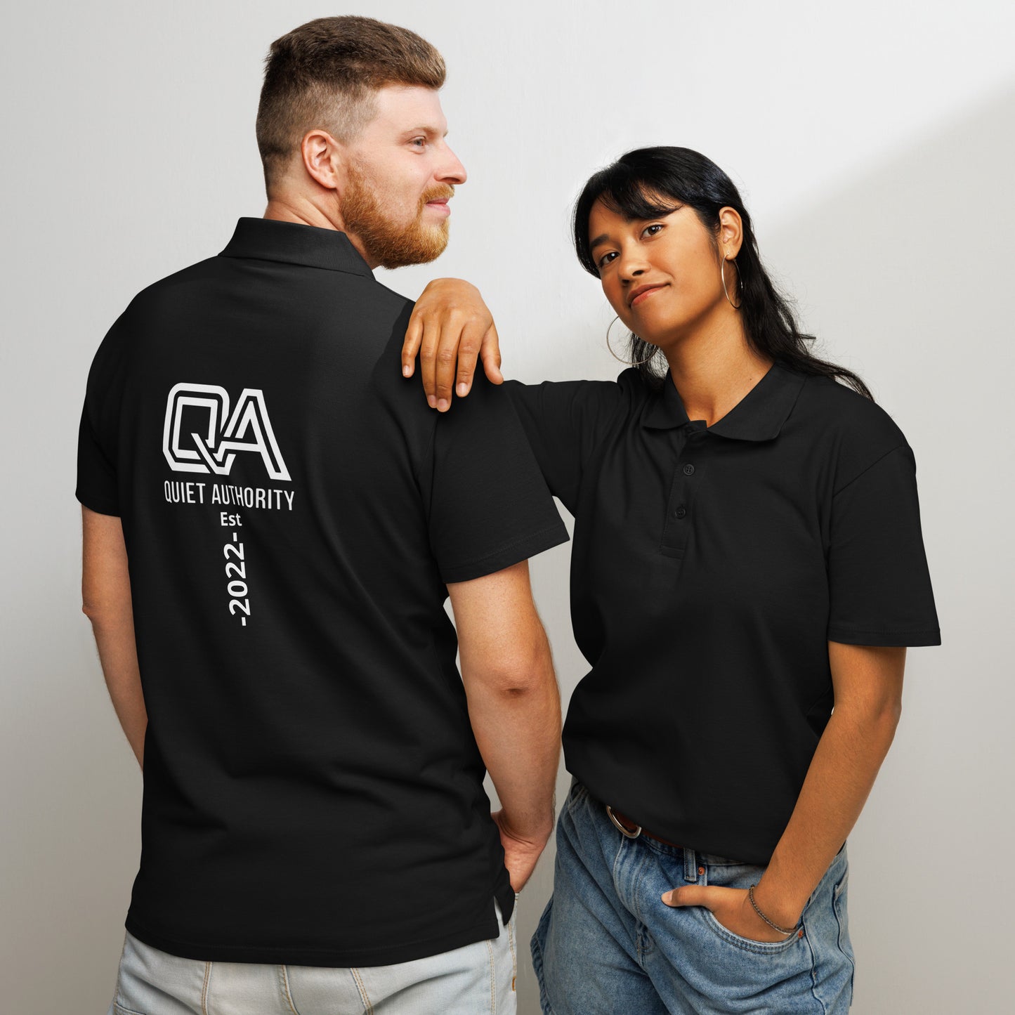 Unisex black Piqué Polo Shirt by Craftklart, front and back view, showcasing classic collar and textured fabric.