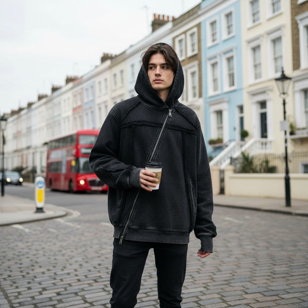 Urban Fashion & Streetwear | Craftklart washed black asymmetric zip-up hoodie with raw-edge fringe on a city street.