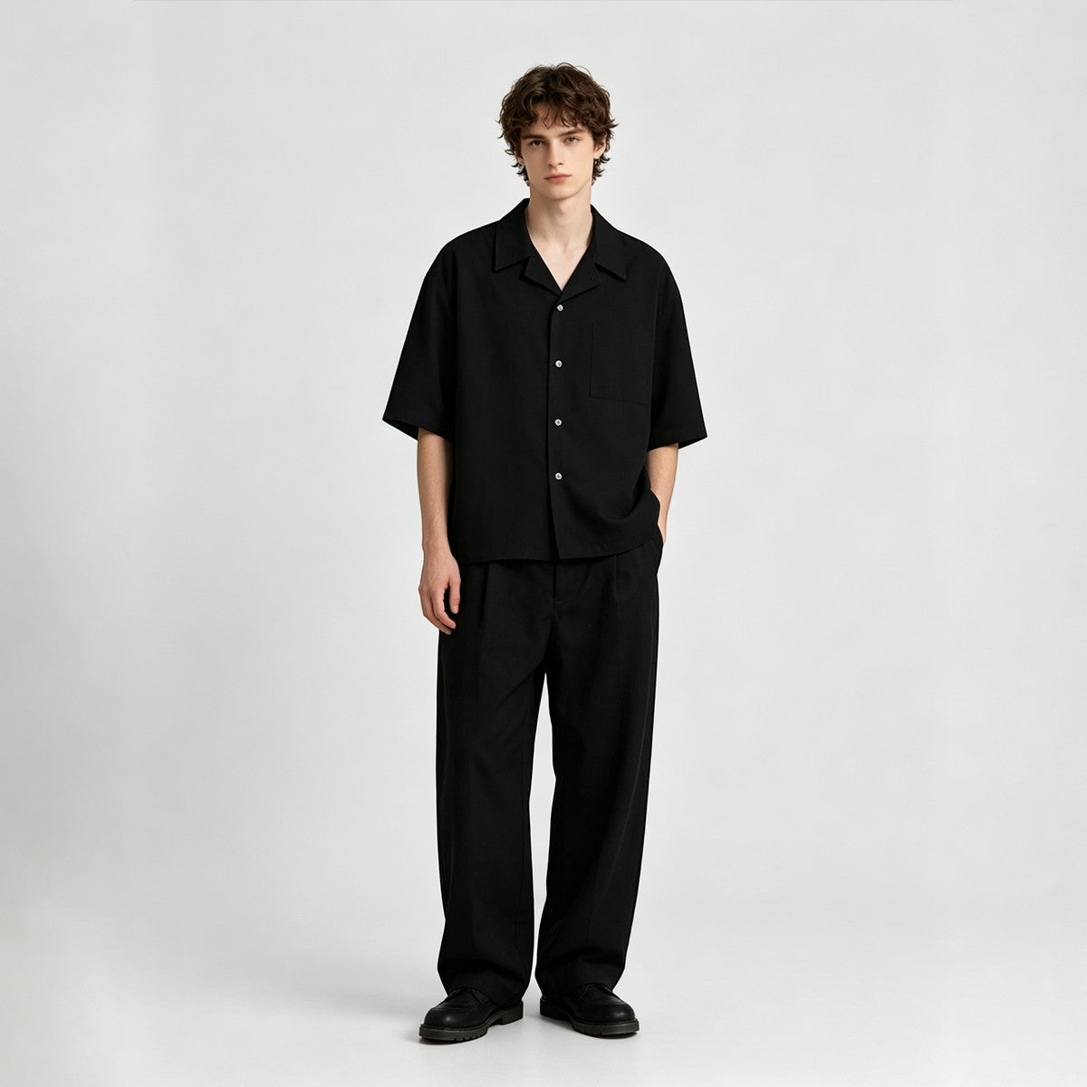 A model wearing an Urban Fashion & Streetwear | Craftklart black cotton Cuban collar shirt with matching trousers.