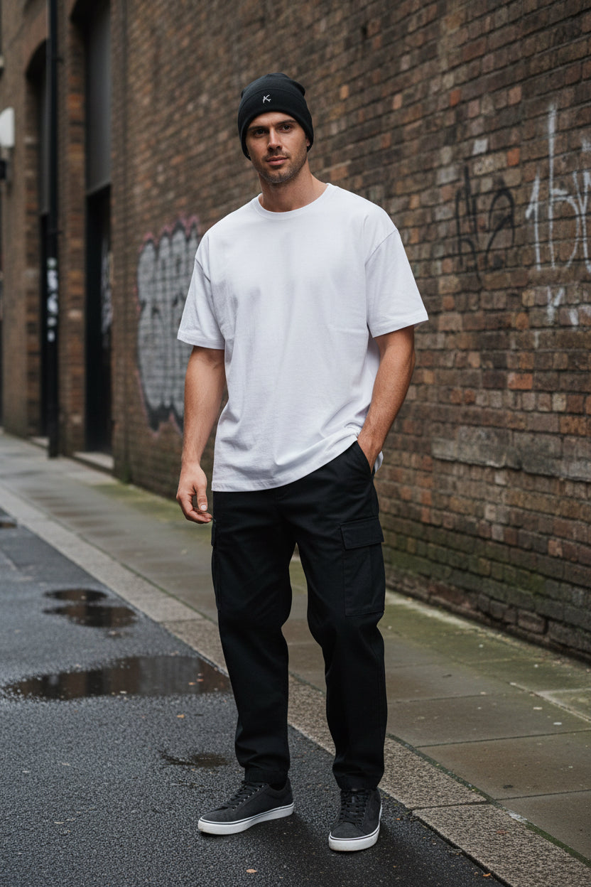 Urban Fashion & Streetwear | Craftklart black embroidered beanie worn by a smiling man in a white t-shirt