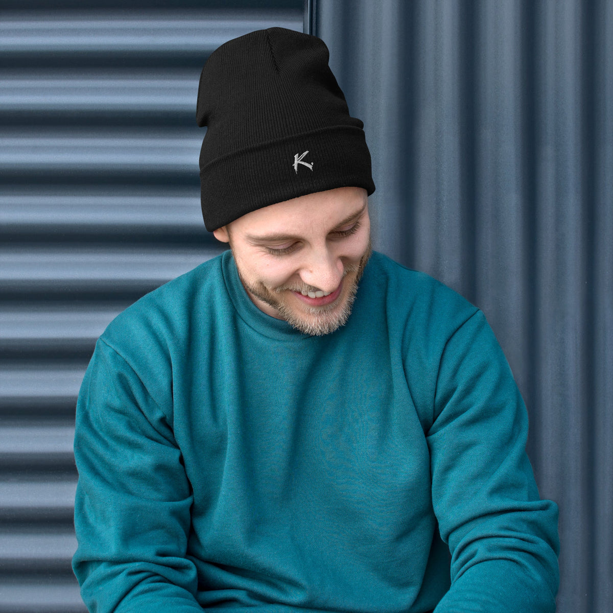 Man wearing a black Urban Fashion & Streetwear | Craftklart embroidered beanie with a snug, form-fitting design.