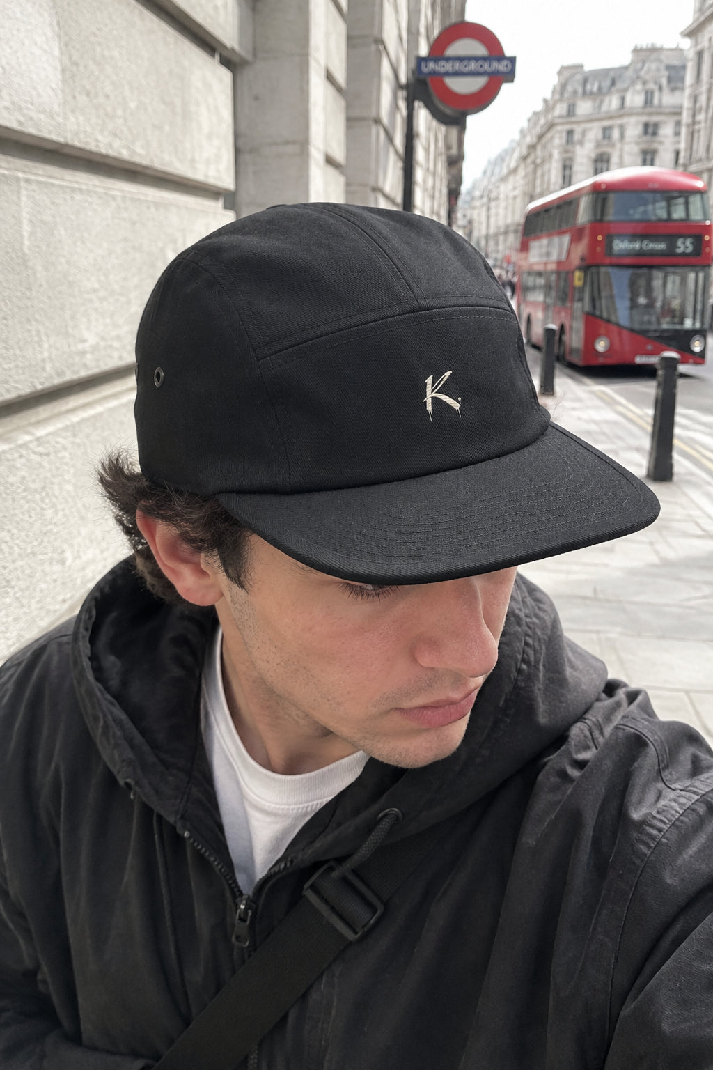 Black C R A F T K L A R T five-panel baseball cap with urban streetwear style, featuring a sleek design and adjustable strap.