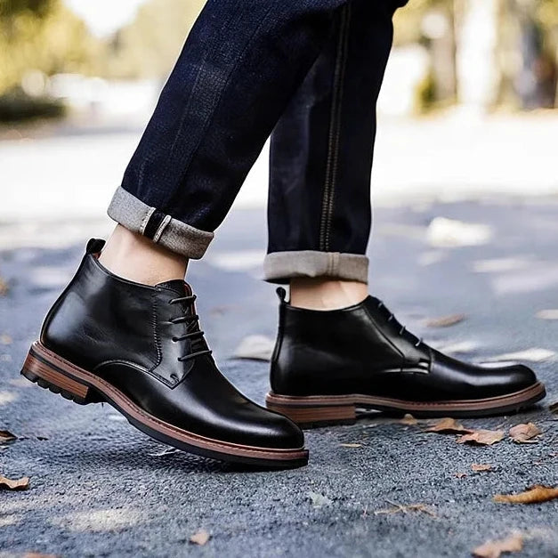 Urban Fashion & Streetwear | Craftklart black leather lace-up work boots with a rubber sole worn on a city street.