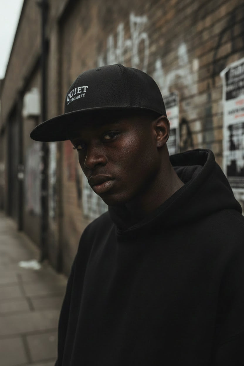 Black Craftklart Quiet Authority Snapback hat, urban streetwear headwear with a structured brim and bold logo design.