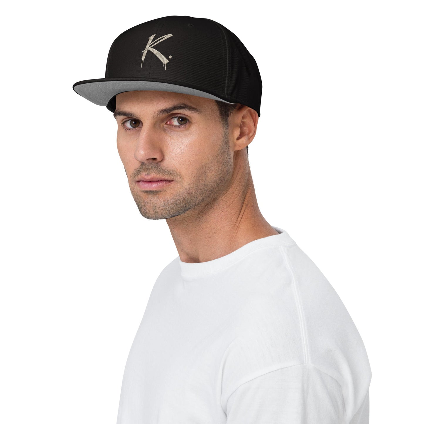Man wearing a black Urban Fashion & Streetwear | Craftklart snapback cap with a flat visor and grey under brim.