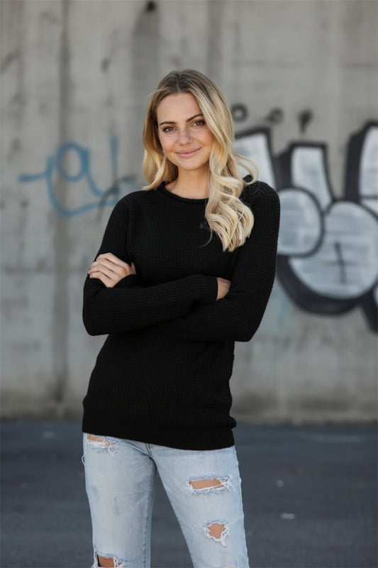 Men's black waffle-knit crewneck sweater by ODMPOD, urban streetwear style, featuring textured knit fabric and casual fit.