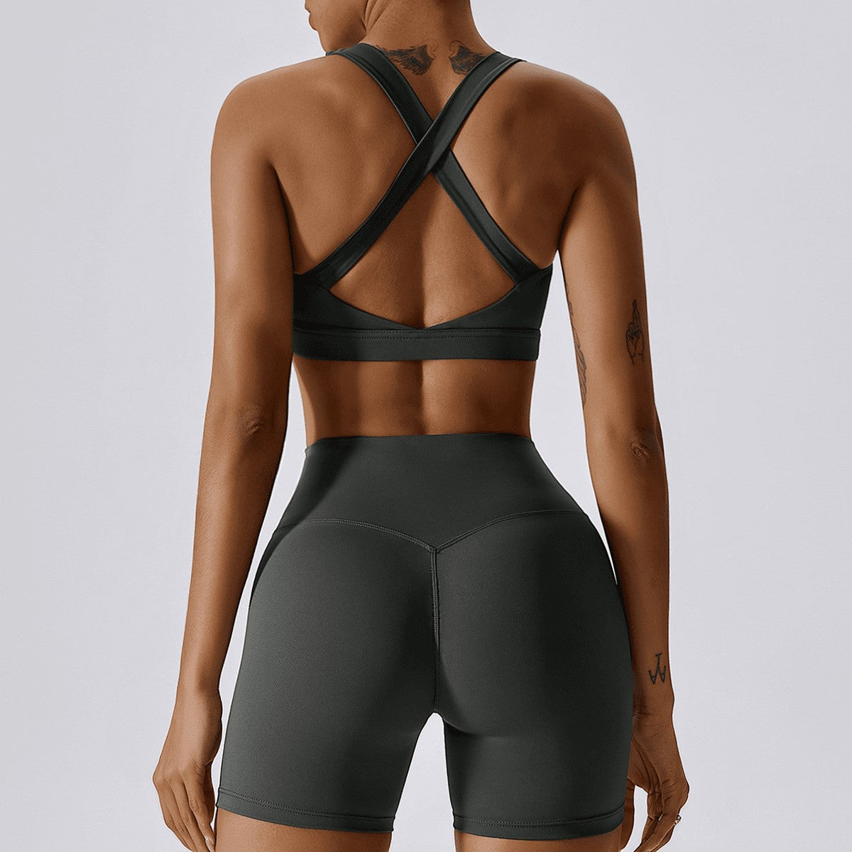 Urban Fashion & Streetwear | Craftklart charcoal grey compression sports bra with a cross-back design on a model