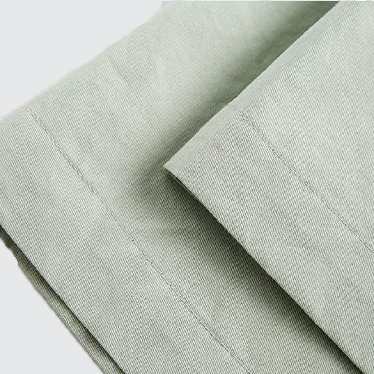 Close-up of sage green 100% cotton fabric with clean stitching from Urban Fashion & Streetwear | Craftklart