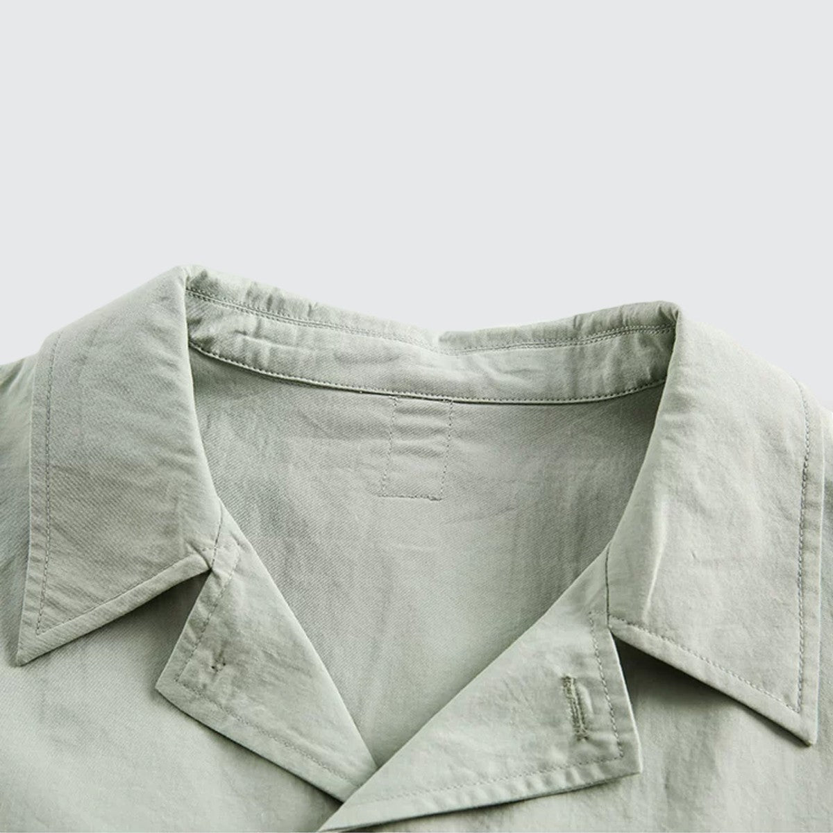 Close-up of the sage green Cuban collar on an Urban Fashion & Streetwear | Craftklart 100% cotton t-shirt.