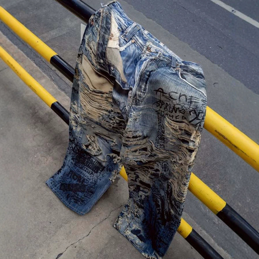 Urban Fashion & Streetwear | Craftklart distressed blue denim jeans with 3D graffiti print and frayed detailing.