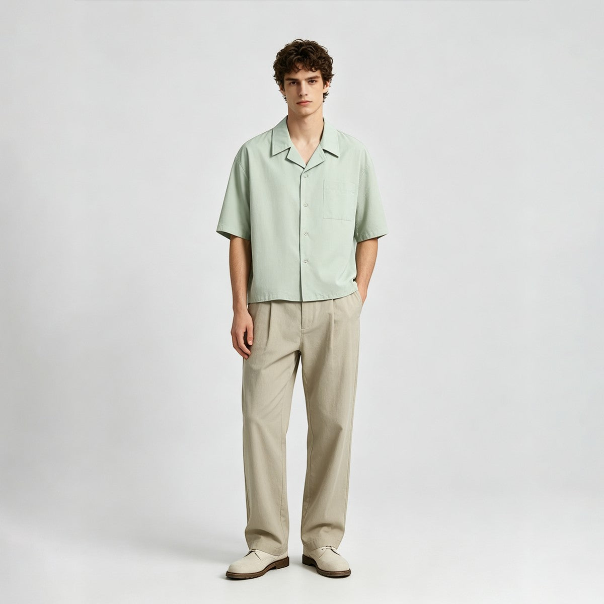 A model wearing a light green Urban Fashion & Streetwear | Craftklart cotton Cuban collar shirt with beige trousers.