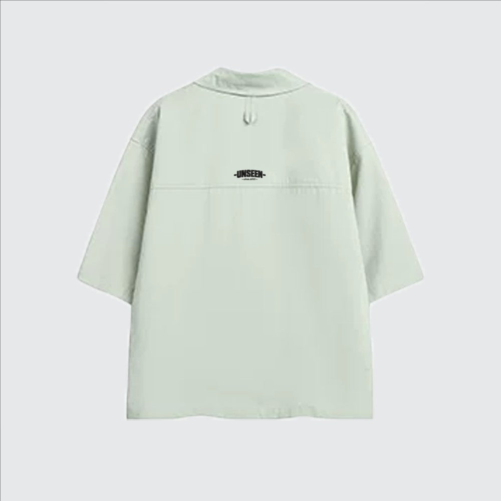 Back view of a light green Urban Fashion & Streetwear | Craftklart cotton Cuban collar t-shirt with Unseen logo