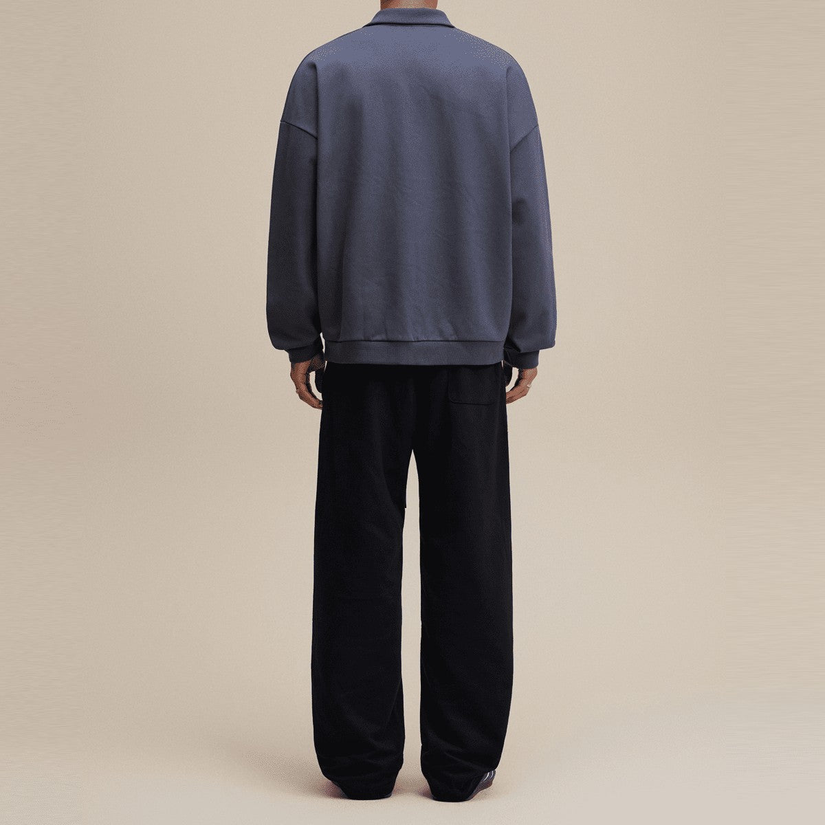 Back view of a man wearing a dark grey half-placket polo collar sweatshirt from Urban Fashion & Streetwear | Craftklart