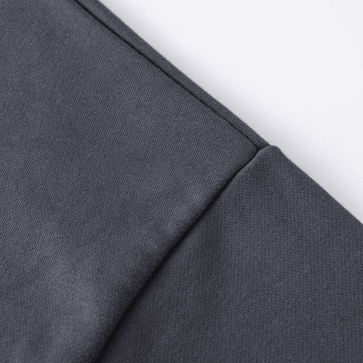 Close-up of the dark grey fabric and seam detail on a Urban Fashion & Streetwear | Craftklart polo sweatshirt.