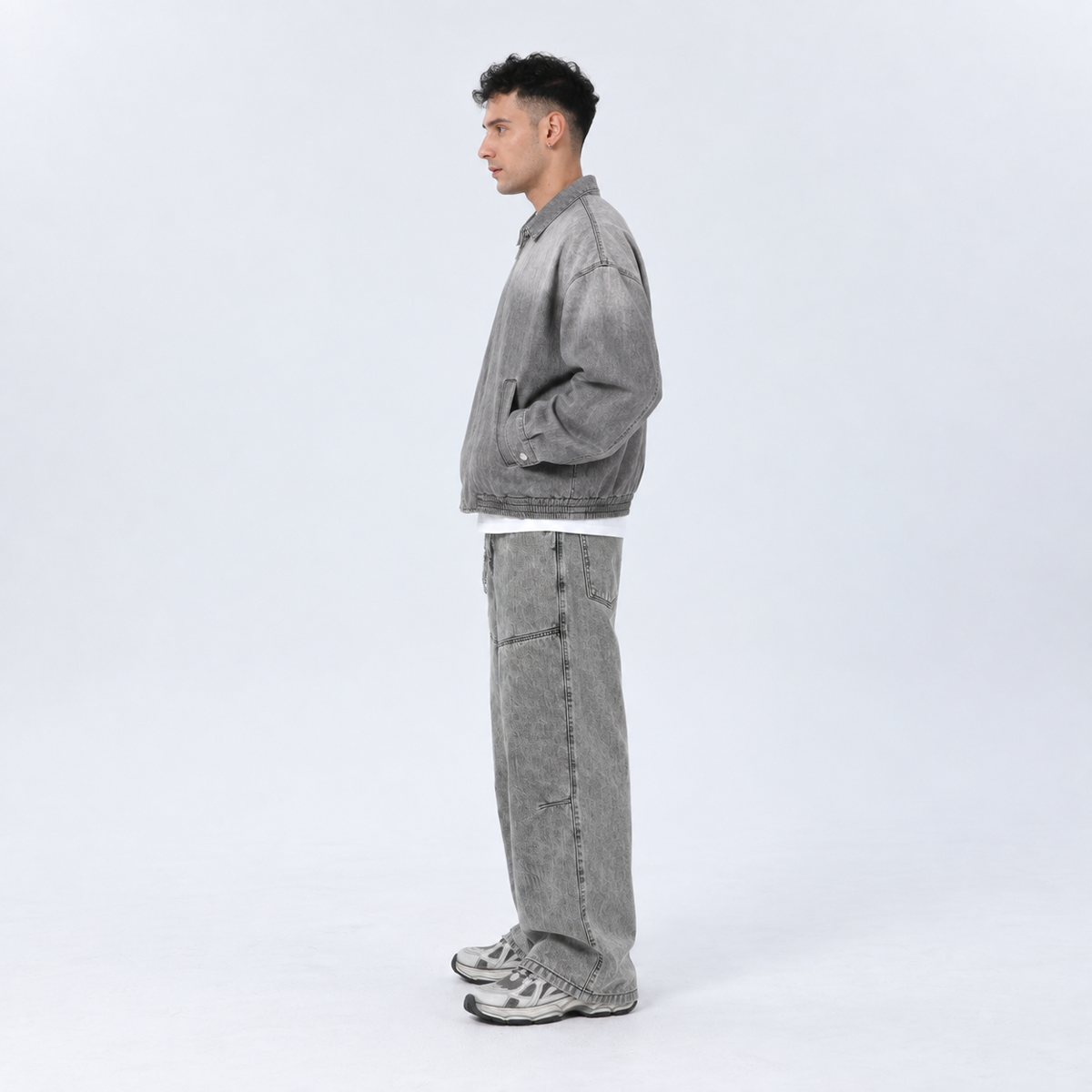A model wearing the Urban Fashion & Streetwear | Craftklart Ashline light grey washed denim zip jacket, side view.