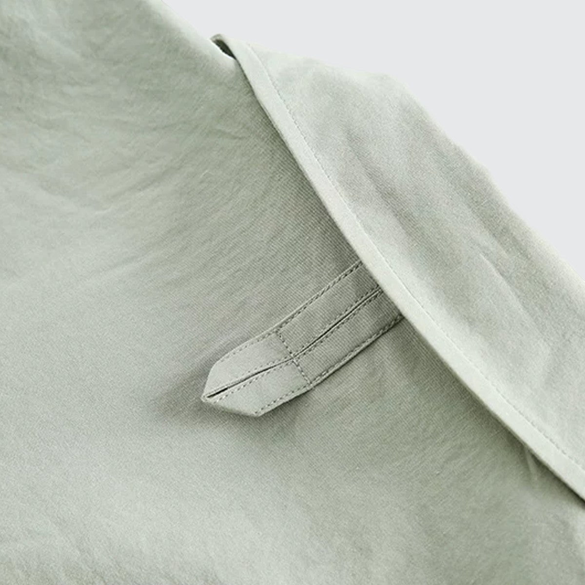 Close-up of the sage green cotton fabric and clean stitching detail on an Urban Fashion & Streetwear | Craftklart shirt
