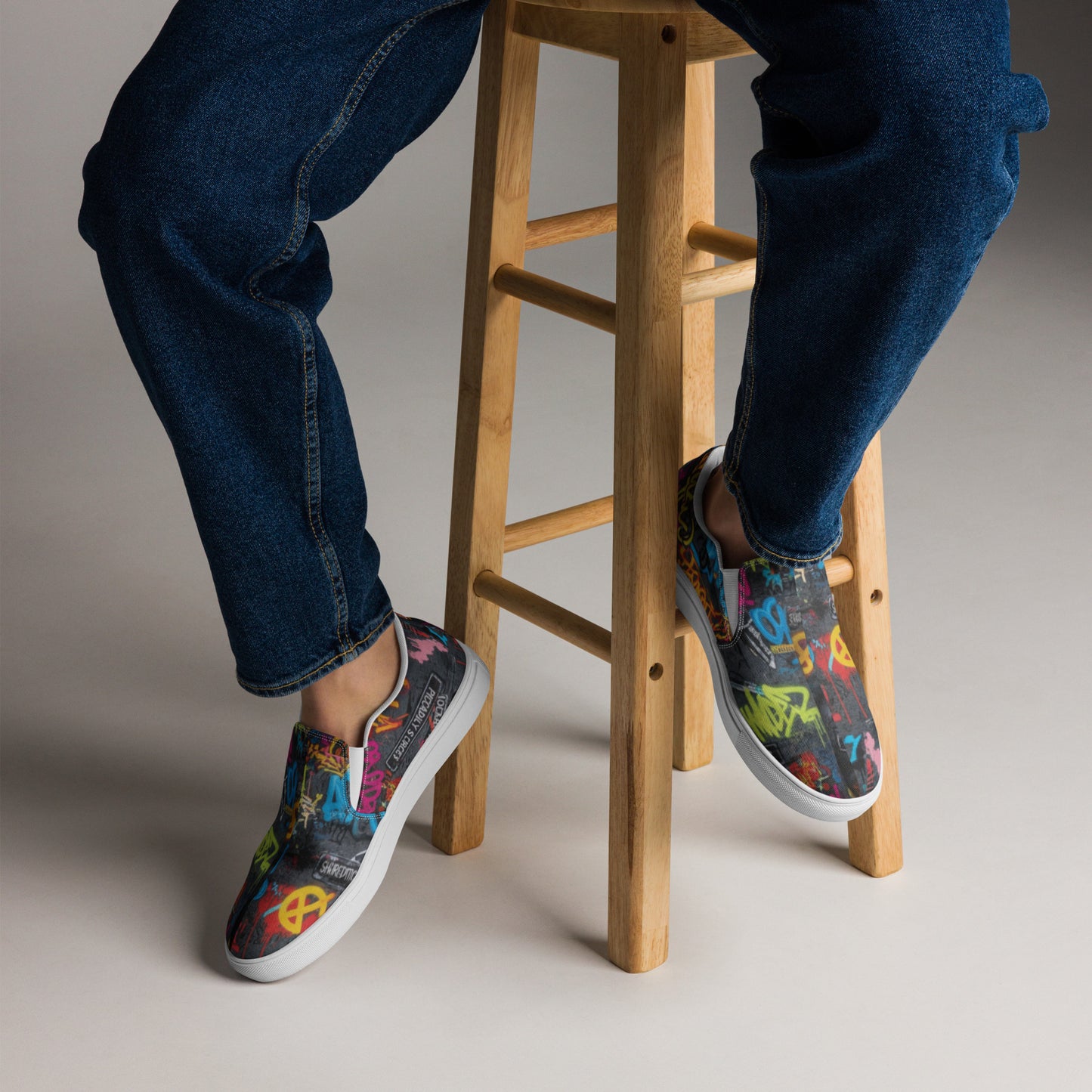 Men’s graffiti slip-on canvas shoes by Urban Fashion & Streetwear Craftklart featuring vibrant street art designs on casual shoes.