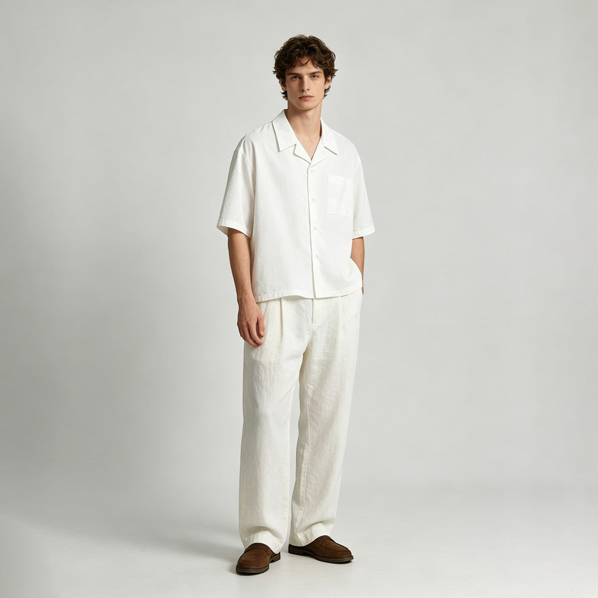 A male model wearing an Urban Fashion & Streetwear | Craftklart white cotton Cuban collar shirt and matching trousers.